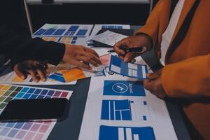 The designer team is designing the uxui system to make the uxui system work well on new phones and support system updates. Website development concept UI UX front end designer photo