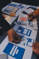 The designer team is designing the uxui system to make the uxui system work well on new phones and support system updates. Website development concept UI UX front end designer photo