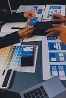 The designer team is designing the uxui system to make the uxui system work well on new phones and support system updates. Website development concept UI UX front end designer photo