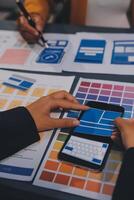 The designer team is designing the uxui system to make the uxui system work well on new phones and support system updates. Website development concept UI UX front end designer photo