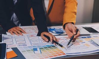 The designer team is designing the uxui system to make the uxui system work well on new phones and support system updates. Website development concept UI UX front end designer photo