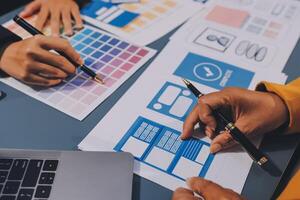 The designer team is designing the uxui system to make the uxui system work well on new phones and support system updates. Website development concept UI UX front end designer photo
