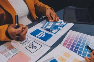 The designer team is designing the uxui system to make the uxui system work well on new phones and support system updates. Website development concept UI UX front end designer photo