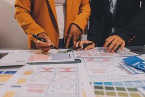The designer team is designing the uxui system to make the uxui system work well on new phones and support system updates. Website development concept UI UX front end designer photo