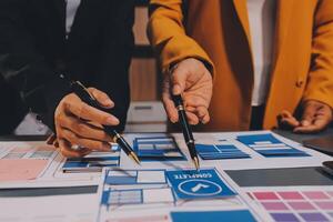 The designer team is designing the uxui system to make the uxui system work well on new phones and support system updates. Website development concept UI UX front end designer photo