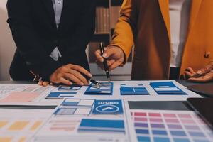 The designer team is designing the uxui system to make the uxui system work well on new phones and support system updates. Website development concept UI UX front end designer photo