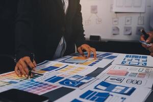 The designer team is designing the uxui system to make the uxui system work well on new phones and support system updates. Website development concept UI UX front end designer photo