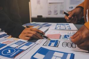The designer team is designing the uxui system to make the uxui system work well on new phones and support system updates. Website development concept UI UX front end designer photo