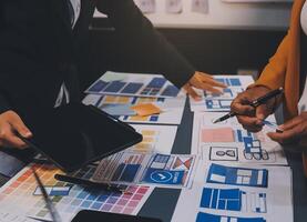 The designer team is designing the uxui system to make the uxui system work well on new phones and support system updates. Website development concept UI UX front end designer photo