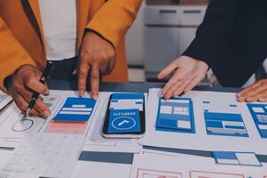 The designer team is designing the uxui system to make the uxui system work well on new phones and support system updates. Website development concept UI UX front end designer photo