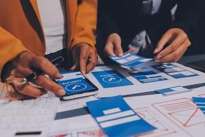 The designer team is designing the uxui system to make the uxui system work well on new phones and support system updates. Website development concept UI UX front end designer photo
