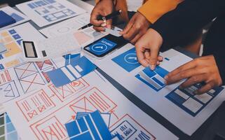 The designer team is designing the uxui system to make the uxui system work well on new phones and support system updates. Website development concept UI UX front end designer photo
