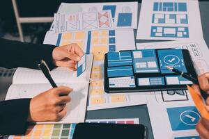 The designer team is designing the uxui system to make the uxui system work well on new phones and support system updates. Website development concept UI UX front end designer photo