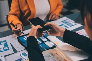 The designer team is designing the uxui system to make the uxui system work well on new phones and support system updates. Website development concept UI UX front end designer photo