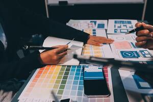 The designer team is designing the uxui system to make the uxui system work well on new phones and support system updates. Website development concept UI UX front end designer photo