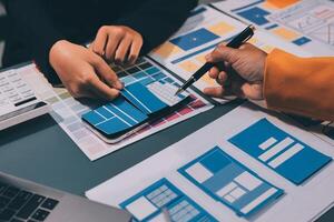 The designer team is designing the uxui system to make the uxui system work well on new phones and support system updates. Website development concept UI UX front end designer photo