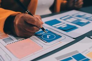 The designer team is designing the uxui system to make the uxui system work well on new phones and support system updates. Website development concept UI UX front end designer photo