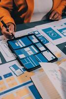 The designer team is designing the uxui system to make the uxui system work well on new phones and support system updates. Website development concept UI UX front end designer photo