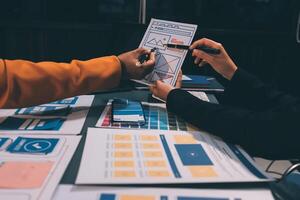 The designer team is designing the uxui system to make the uxui system work well on new phones and support system updates. Website development concept UI UX front end designer photo