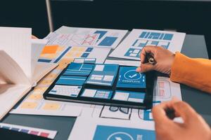 The designer team is designing the uxui system to make the uxui system work well on new phones and support system updates. Website development concept UI UX front end designer photo