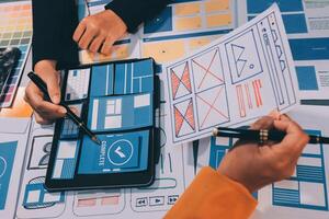 The designer team is designing the uxui system to make the uxui system work well on new phones and support system updates. Website development concept UI UX front end designer photo