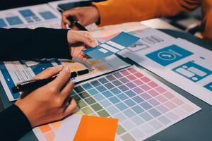 The designer team is designing the uxui system to make the uxui system work well on new phones and support system updates. Website development concept UI UX front end designer photo