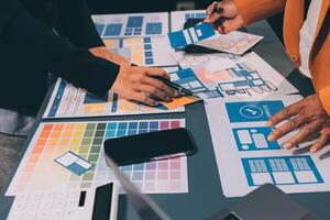 The designer team is designing the uxui system to make the uxui system work well on new phones and support system updates. Website development concept UI UX front end designer photo