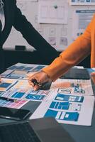 The designer team is designing the uxui system to make the uxui system work well on new phones and support system updates. Website development concept UI UX front end designer photo