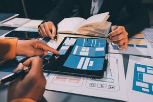 The designer team is designing the uxui system to make the uxui system work well on new phones and support system updates. Website development concept UI UX front end designer photo