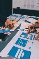 The designer team is designing the uxui system to make the uxui system work well on new phones and support system updates. Website development concept UI UX front end designer photo