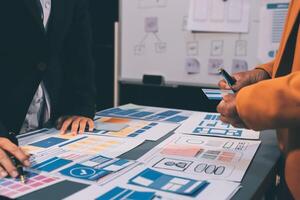 The designer team is designing the uxui system to make the uxui system work well on new phones and support system updates. Website development concept UI UX front end designer photo
