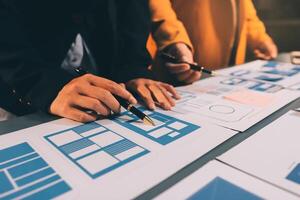 The designer team is designing the uxui system to make the uxui system work well on new phones and support system updates. Website development concept UI UX front end designer photo