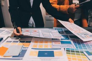 The designer team is designing the uxui system to make the uxui system work well on new phones and support system updates. Website development concept UI UX front end designer photo