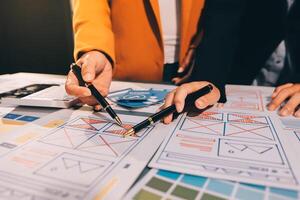 The designer team is designing the uxui system to make the uxui system work well on new phones and support system updates. Website development concept UI UX front end designer photo