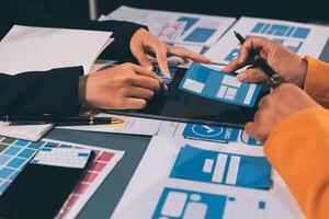 The designer team is designing the uxui system to make the uxui system work well on new phones and support system updates. Website development concept UI UX front end designer photo