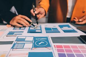 The designer team is designing the uxui system to make the uxui system work well on new phones and support system updates. Website development concept UI UX front end designer photo