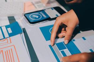 The designer team is designing the uxui system to make the uxui system work well on new phones and support system updates. Website development concept UI UX front end designer photo