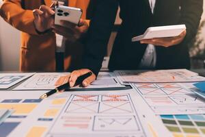 The designer team is designing the uxui system to make the uxui system work well on new phones and support system updates. Website development concept UI UX front end designer photo