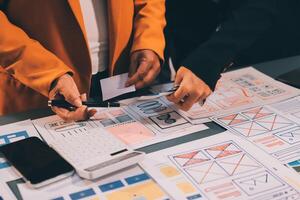 The designer team is designing the uxui system to make the uxui system work well on new phones and support system updates. Website development concept UI UX front end designer photo