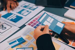 The designer team is designing the uxui system to make the uxui system work well on new phones and support system updates. Website development concept UI UX front end designer photo