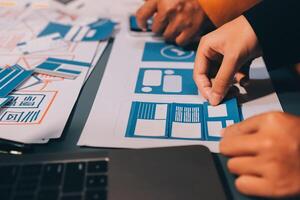 The designer team is designing the uxui system to make the uxui system work well on new phones and support system updates. Website development concept UI UX front end designer photo