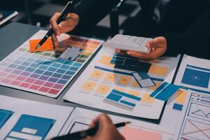 The designer team is designing the uxui system to make the uxui system work well on new phones and support system updates. Website development concept UI UX front end designer photo