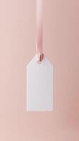Rectangular white blank paper tag label price tag with hanging rope isolated pink photo
