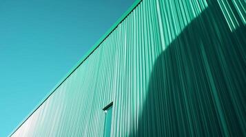 Wall of warehouse green metal building against industrial with blue sky background in perspective view photo