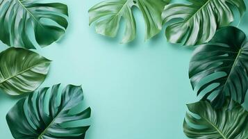 Monstera leaves frame border copy space empty center blue background photo