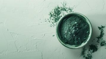 Spirulina flour green algae on bowl top of view for natural ingredient photo
