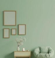 Green sage color sofa with blank frame mockup on green wall photo