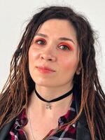 Joyful modern rock style portrait. Woman with dreadlocks and grunge style clothing and make up photo