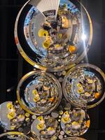 Shimmering Reflections from Spherical Mirrors on a Modern Ceiling. Geometry and Light Creates a Captivating Artistic Display in a Public Space. photo
