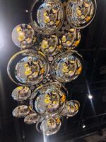 Shimmering Reflections from Spherical Mirrors on a Modern Ceiling. Geometry and Light Creates a Captivating Artistic Display in a Public Space. photo